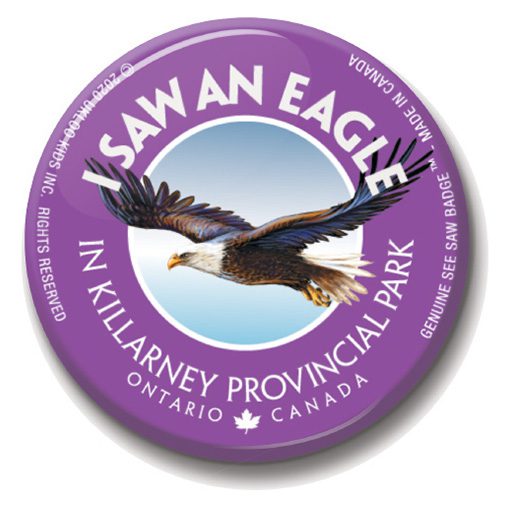 A purple button with an eagle in the center.