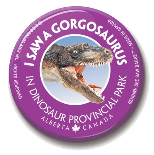 A purple button with an image of a dinosaur.